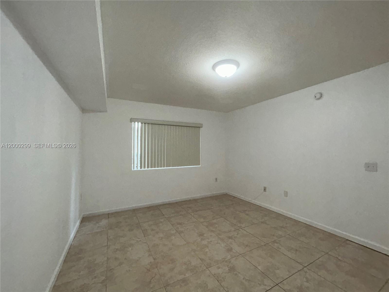 15470 Southwest 284th Street, Unit 3103 Homestead, FL 33033 - Photo 5 of 12 an empty room with a window