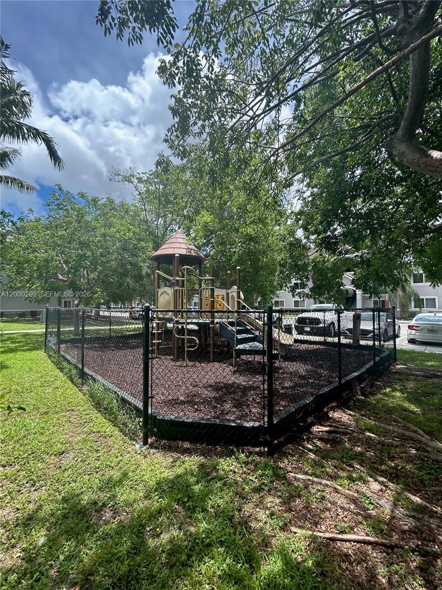 15470 Southwest 284th Street, Unit 3103 Homestead, FL 33033 - Photo 9 of 12 a view of a backyard with trees