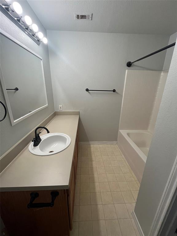 403 East R Ellis Avenue Fate, TX 75087 - Photo 14 of 15 a bathroom with a sink a toilet and a mirror