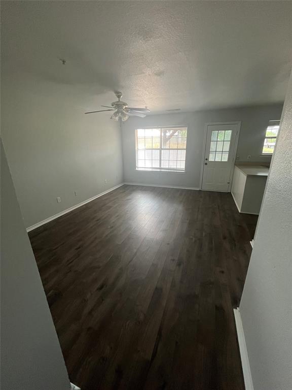 403 East R Ellis Avenue Fate, TX 75087 - Photo 5 of 15 an empty room with wooden floor and windows