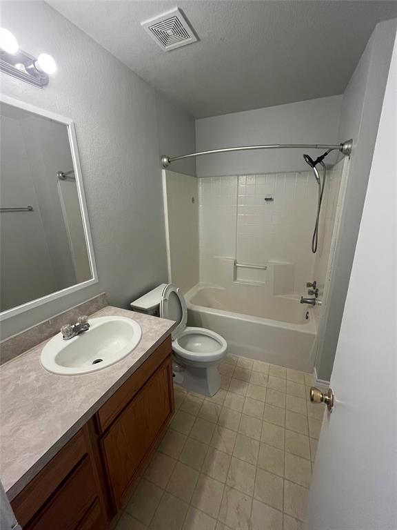 403 East R Ellis Avenue Fate, TX 75087 - Photo 10 of 15 a bathroom with a granite countertop sink toilet a mirror and shower