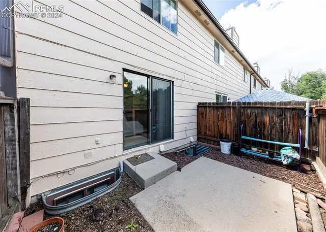 a view of a backyard with wooden fence
