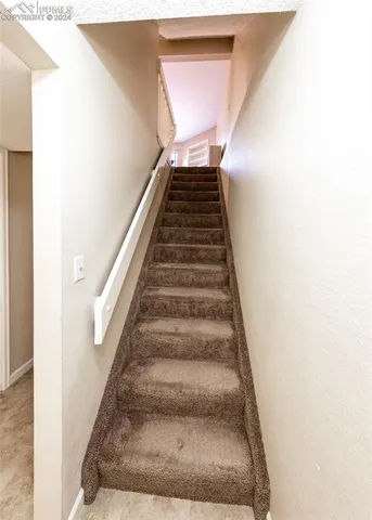 a spacious bedroom with a bed and a dresser in it