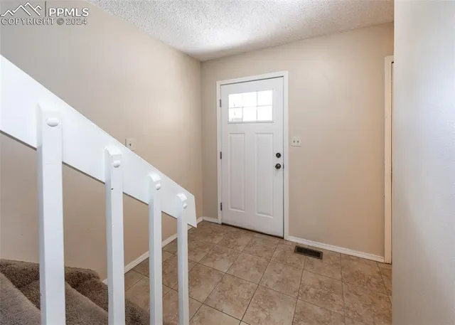 a view of a hallway with wooden floor and entryway