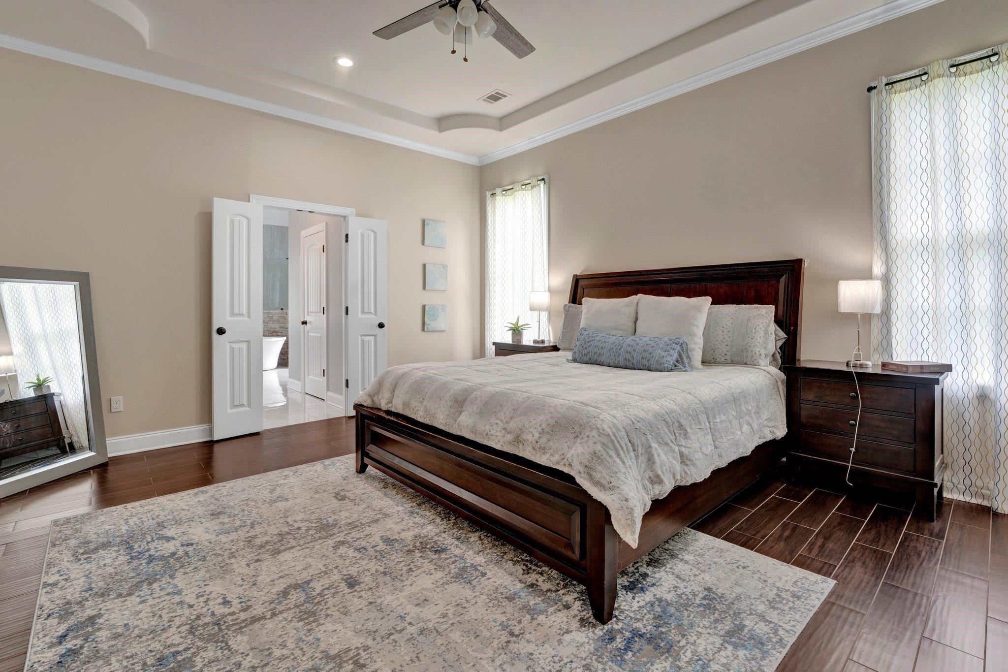 3270 Rast Road Millington, TN 38053 - Photo 23 of 40 Bedroom featuring wood finish floors, a tray ceiling, ornamental molding, and a ceiling fan