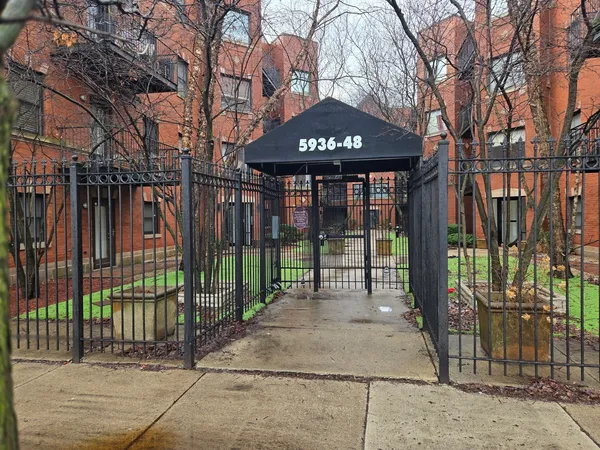 a front view of a house with a iron gate
