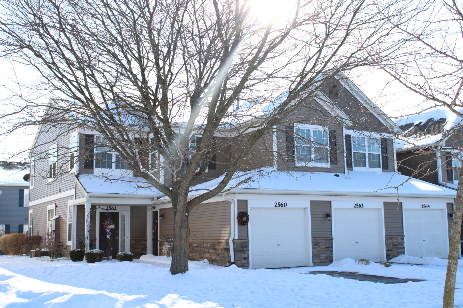 2560 Golf Ridge Circle, Unit 2560 Naperville, IL 60563 - Photo 1 of 16 a front view of a house with a tree