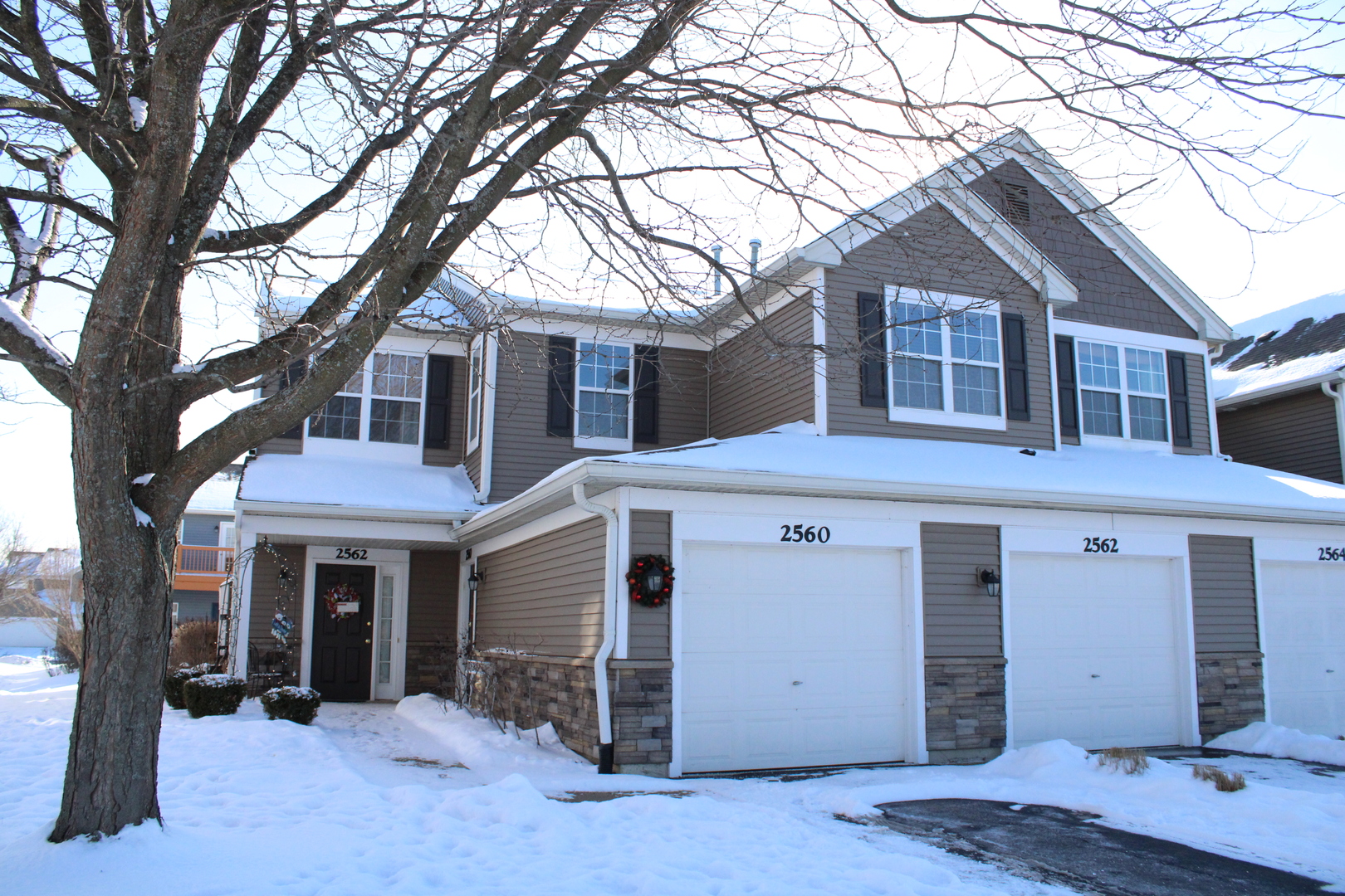 2560 Golf Ridge Circle, Unit 2560 Naperville, IL 60563 - Photo 2 of 16 a front view of a house with a tree