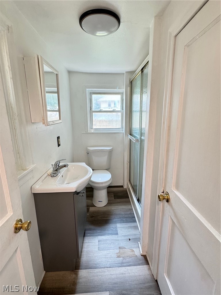 459 Patterson Avenue Akron, OH 44310 - Photo 21 of 24 1st floor appt. Bathroom with wood-type flooring, vanity, and toilet