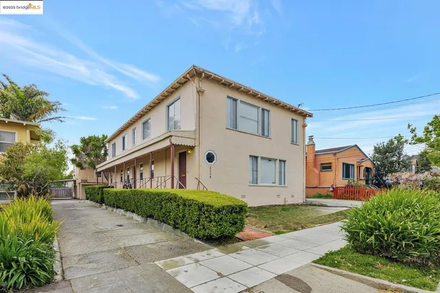 a view of a white house with a yard and plants