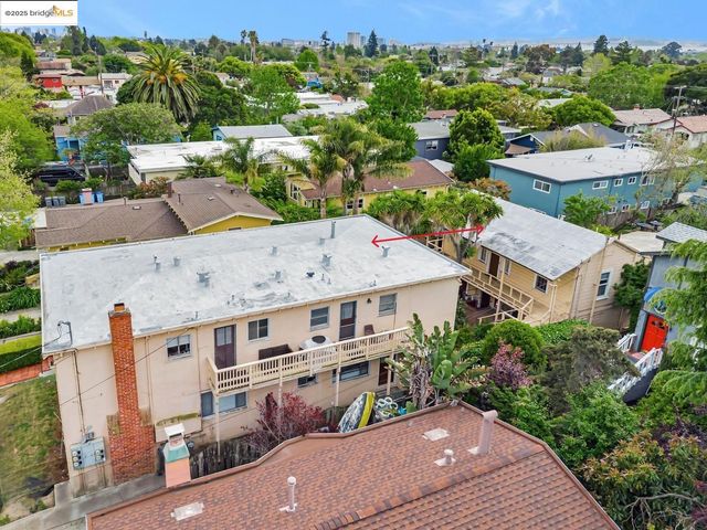 an aerial view of multiple houses with a yard