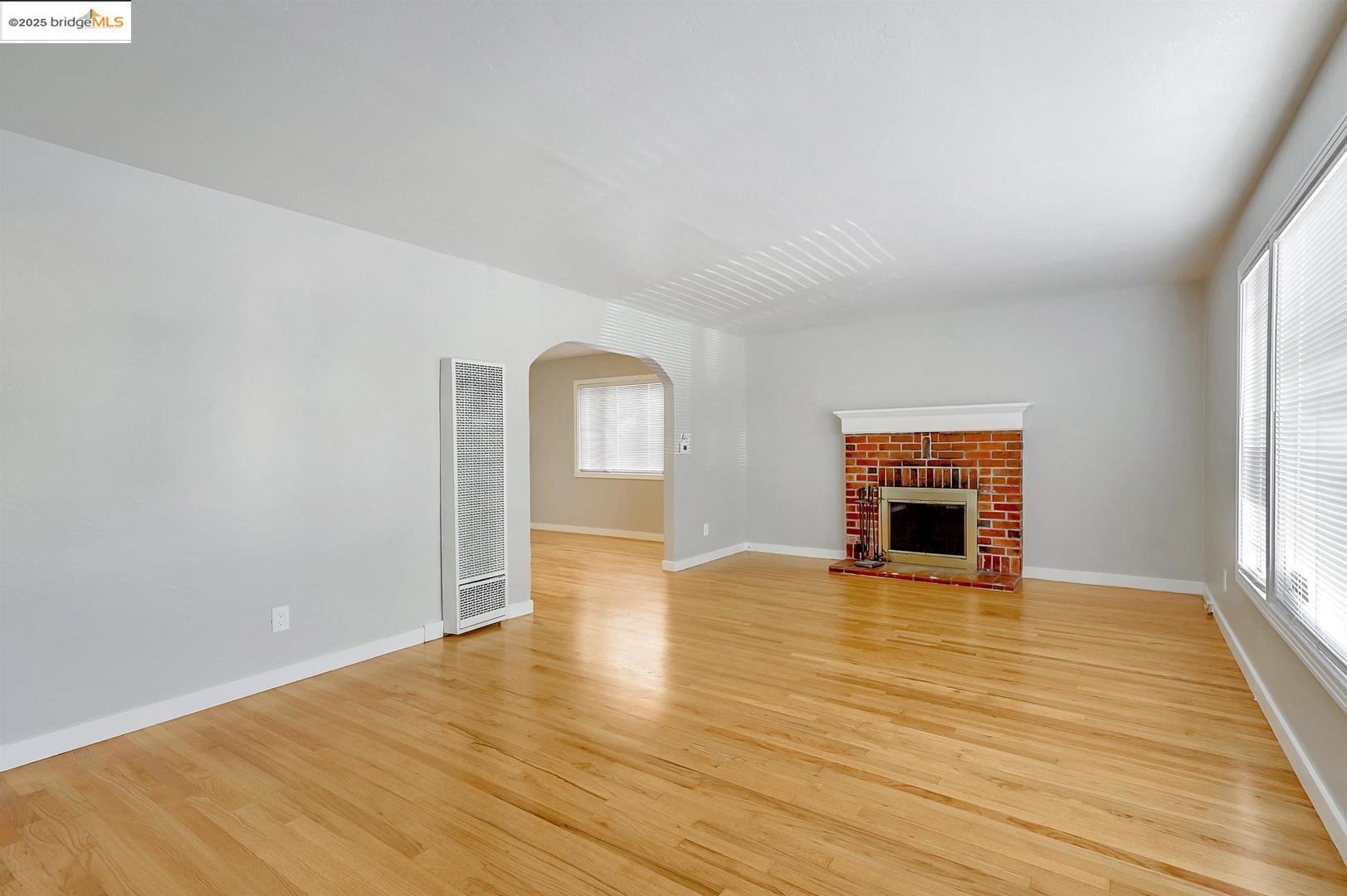 2118 California Street Berkeley, CA 94703 - Photo 19 of 34 a view of empty room with wooden floor and fireplace