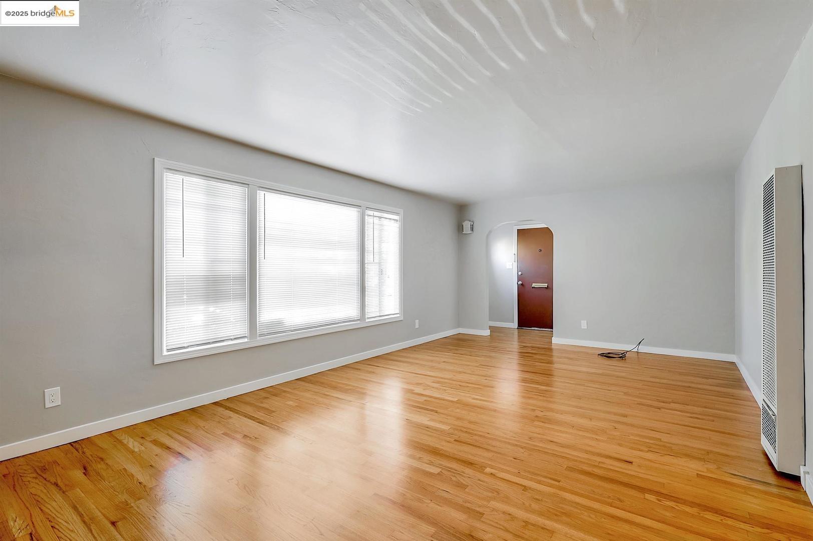 2118 California Street Berkeley, CA 94703 - Photo 20 of 34 a view of an empty room with wooden floor and a window