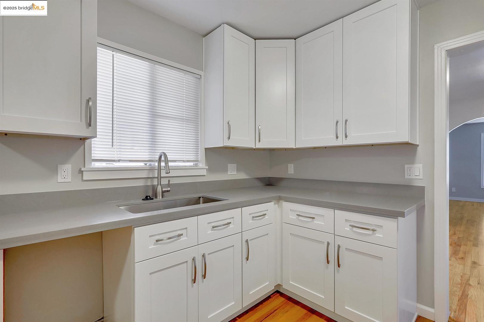 2118 California Street Berkeley, CA 94703 - Photo 25 of 34 a kitchen with white cabinets and a window