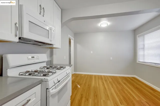 a kitchen with a sink and a stove top oven