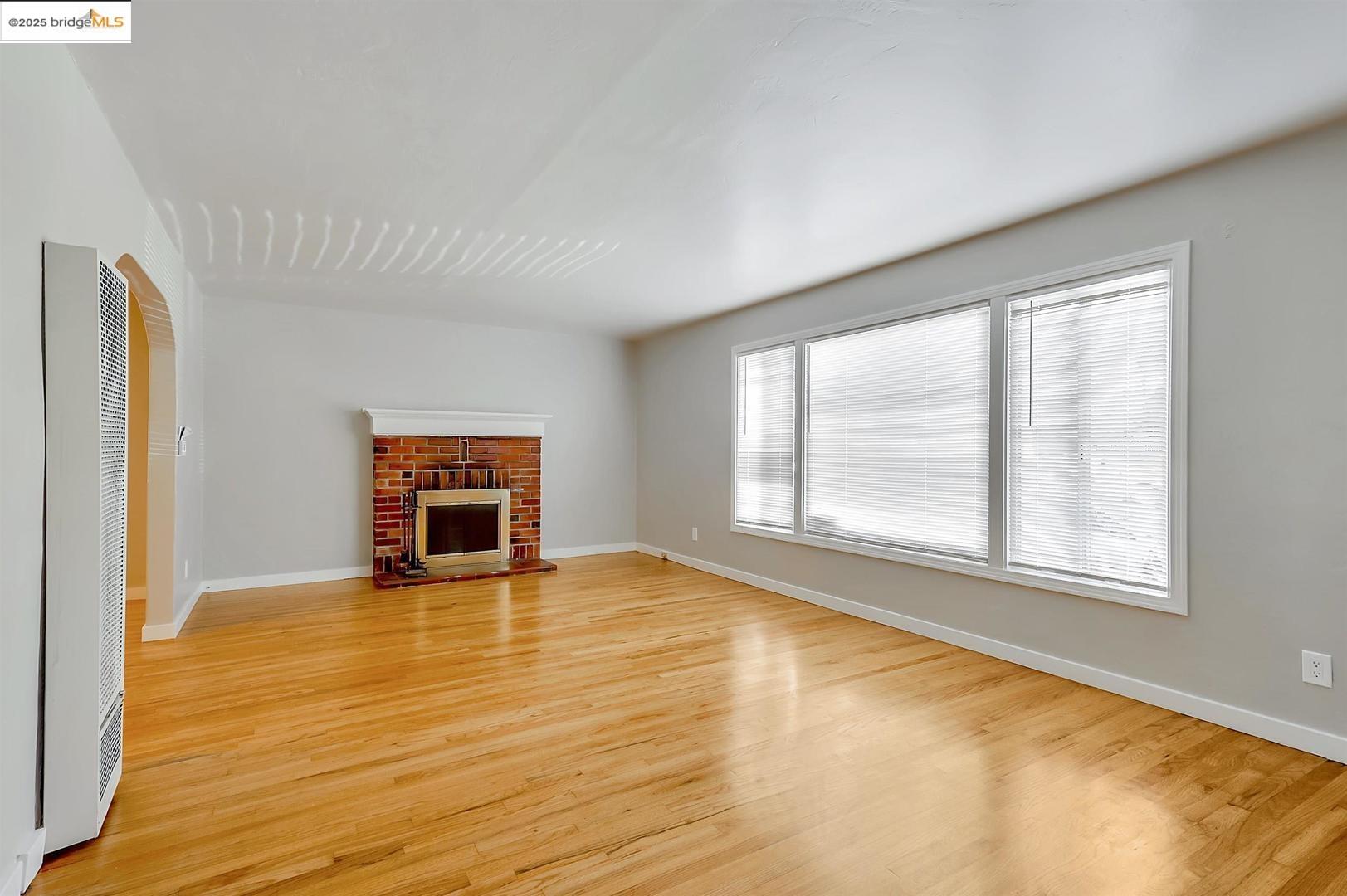2118 California Street Berkeley, CA 94703 - Photo 30 of 34 an empty room with wooden floor and windows