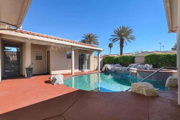 a front view of house with yard and swimming pool