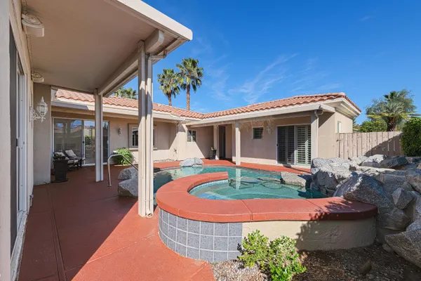 a view of a house with swimming pool and a yard