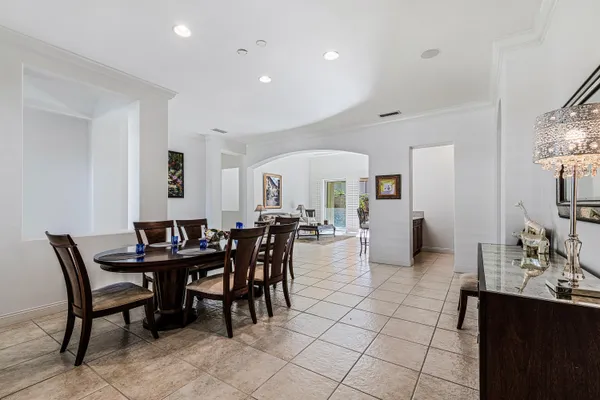 a view of a dining room with furniture and chandelier