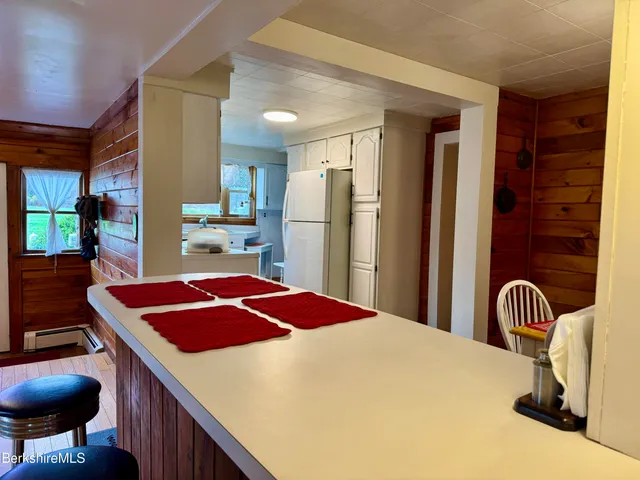 a kitchen with a appliances and a refrigerator
