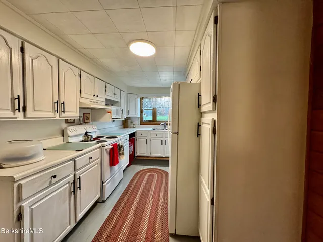 a kitchen with stainless steel appliances granite countertop a lot of counter space and wooden floors