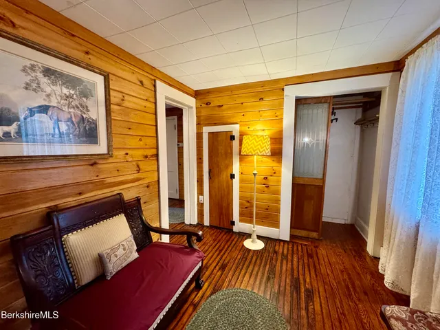 a living room with furniture fireplace and wooden floor