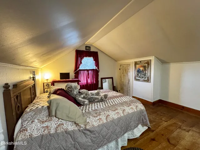 a bedroom with a large bed and a dresser