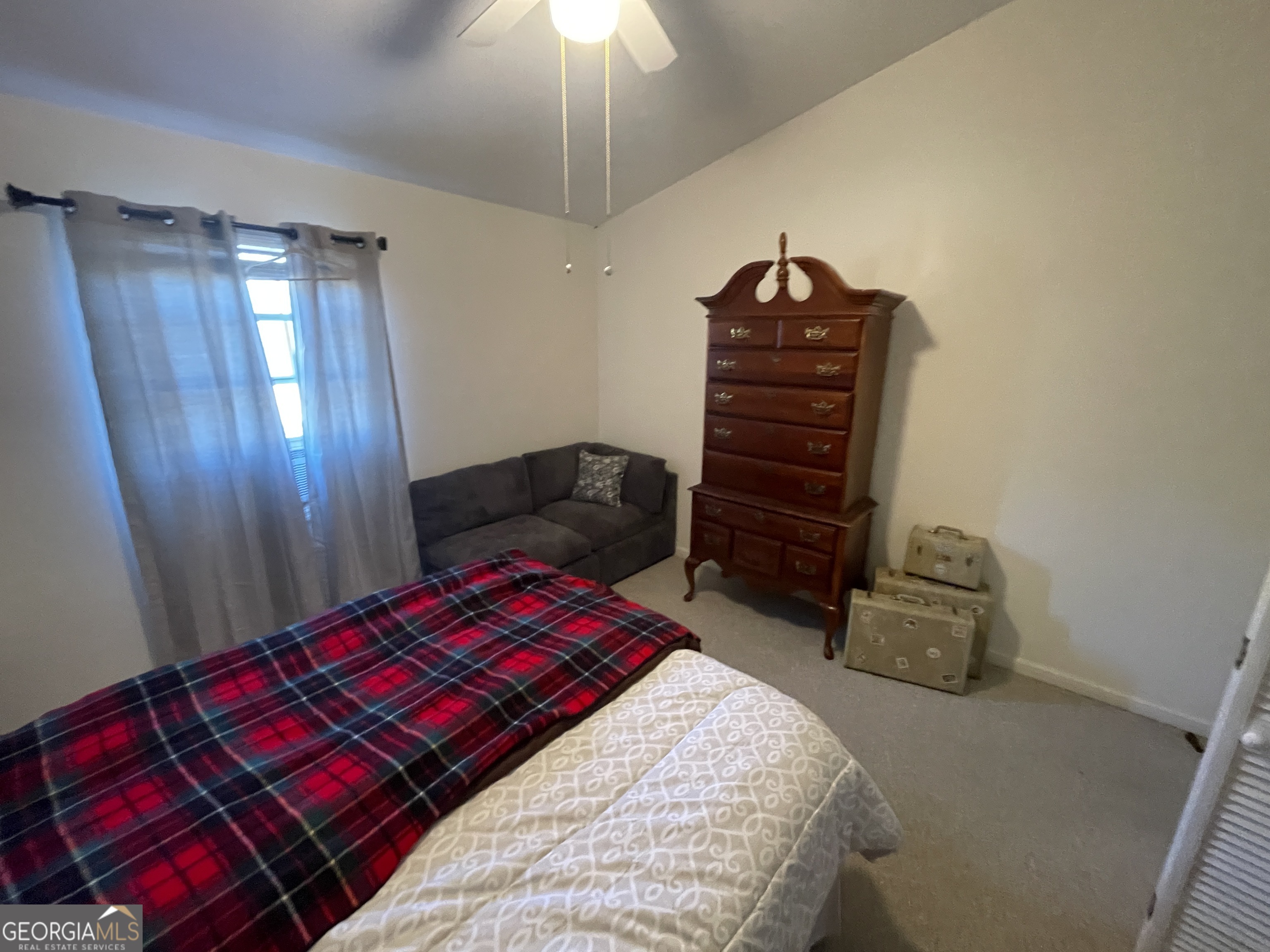 4374 River Road Manchester, GA 31816 - Photo 12 of 13 a bedroom with a bed and a chandelier