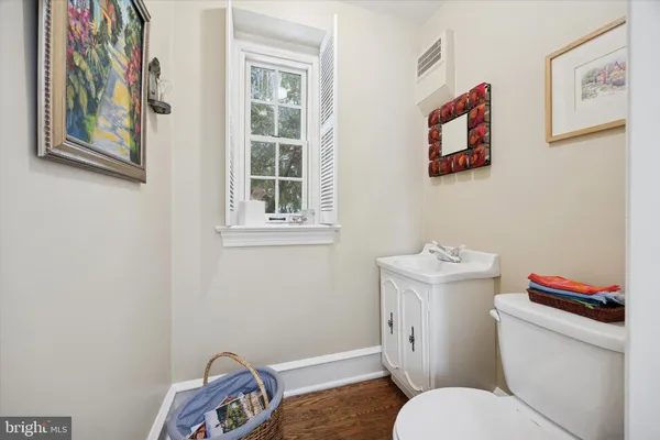 a white toilet sitting next to a bathroom