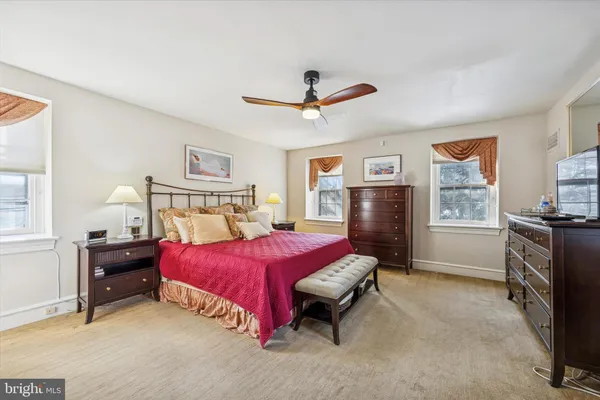 a bedroom with a bed dresser and a window