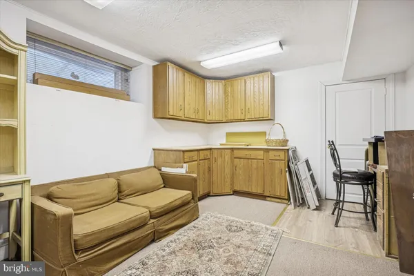 a living room with furniture a kitchen view and a stove