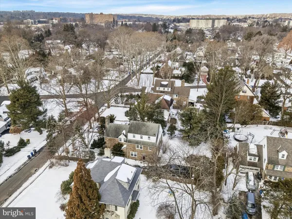 an aerial view of residential houses with city view