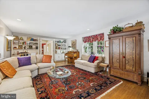 a living room with furniture rug and window
