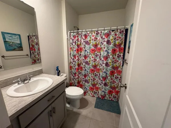a living room with a couch a dining table and a large window with garden view