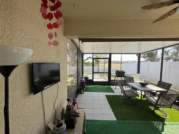 a view of a porch with a floor to ceiling window and wooden fence