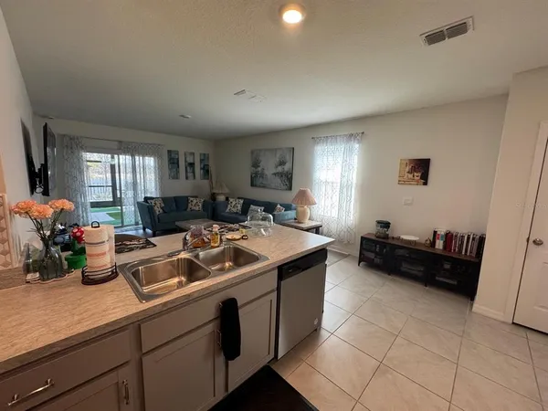 a view of a kitchen with a sink and cabinets