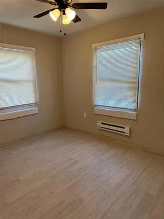 a view of a livingroom with wooden floor and a ceiling fan