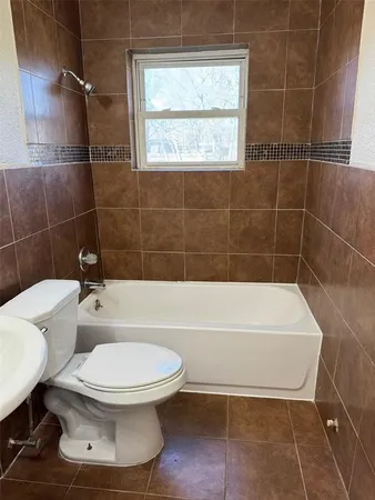 a bathroom with a toilet a sink and a shower