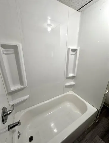 a bathroom with a tub and sink