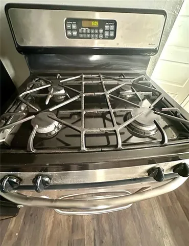 a kitchen with stainless steel appliances a stove a sink and a refrigerator