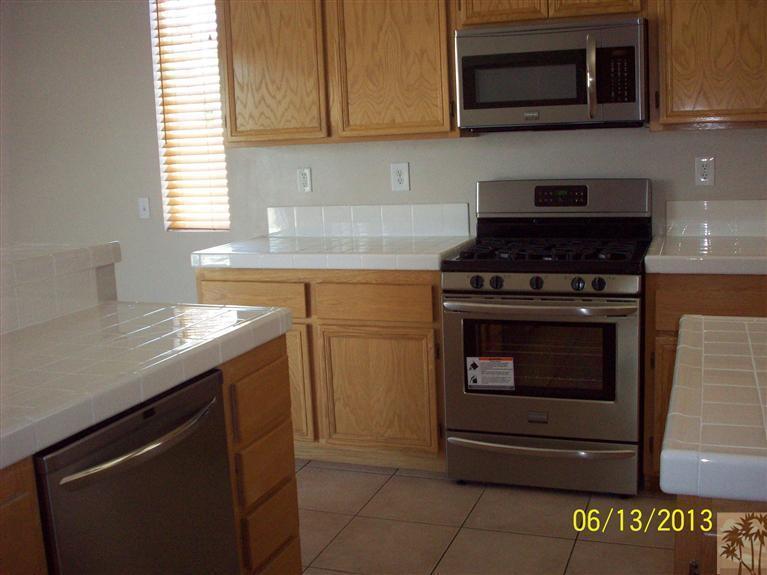 80722 Diamondback Trail Indio, CA 92201 - Photo 3 of 9 a kitchen with stainless steel appliances granite countertop a stove and a microwave