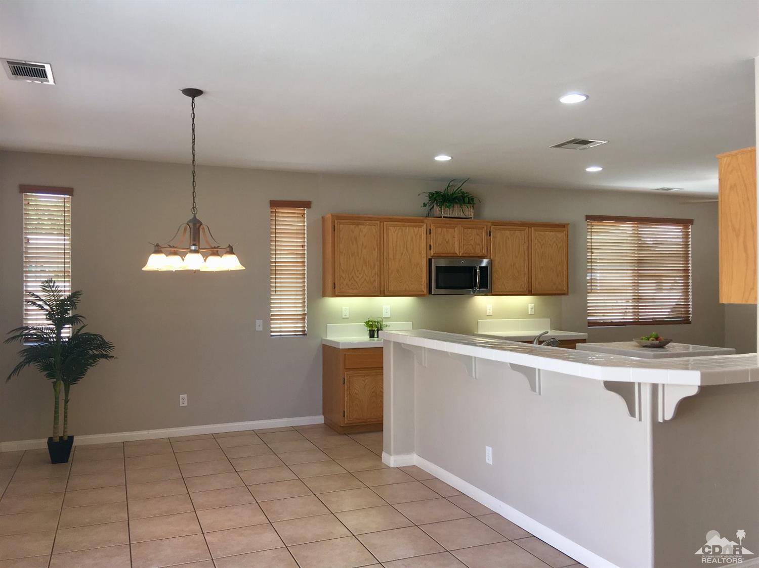 80722 Diamondback Trail Indio, CA 92201 - Photo 5 of 9 a kitchen with stainless steel appliances granite countertop a sink a stove a refrigerator and cabinets