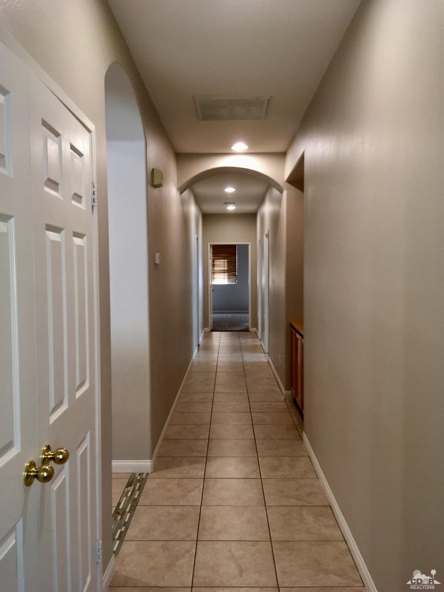 80722 Diamondback Trail Indio, CA 92201 - Photo 6 of 9 a hallway with sliding door and front door