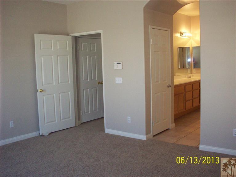 80722 Diamondback Trail Indio, CA 92201 - Photo 7 of 9 an empty room with a bathroom and a mirror