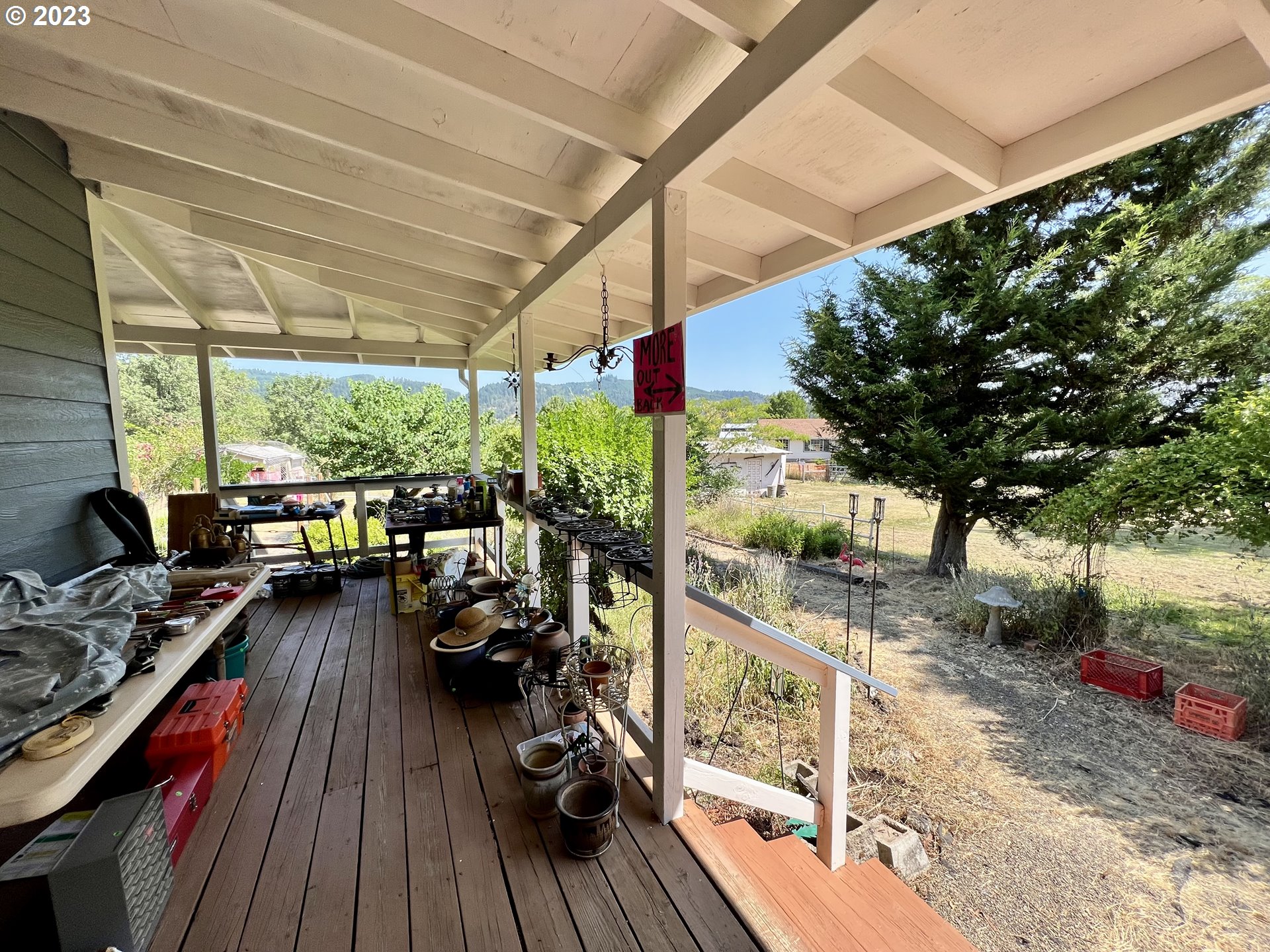 1581 Southside Road Sutherlin, OR 97479 - Photo 26 of 30 a view of a balcony with chairs and wooden floor