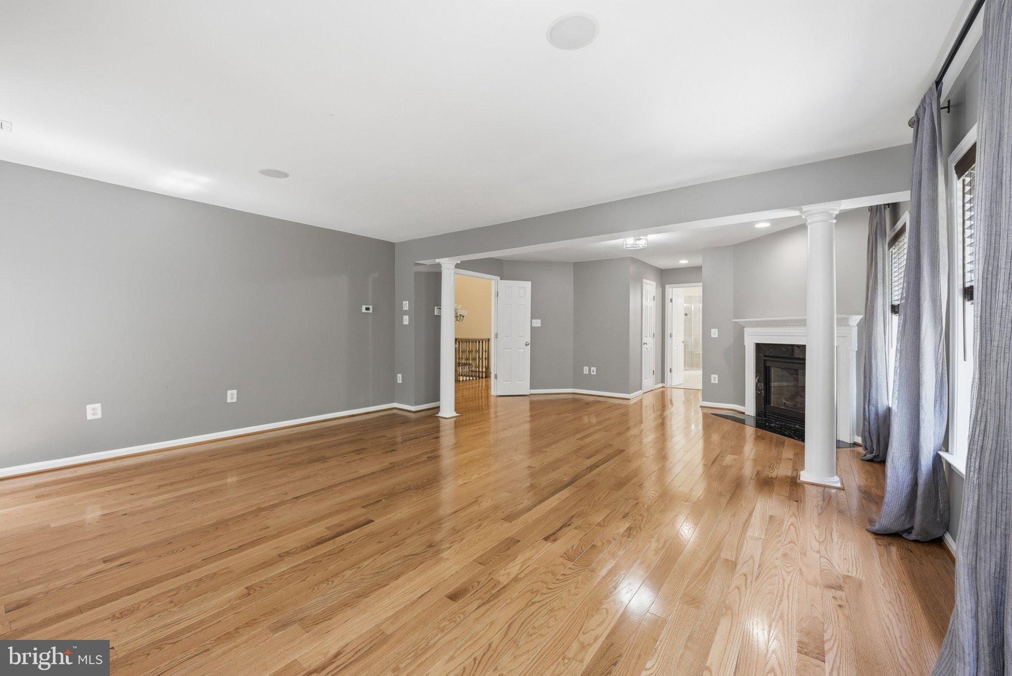 3679 Expedition Drive Triangle, VA 22172 - Photo 30 of 65 a view of a livingroom with wooden floor and a kitchen space