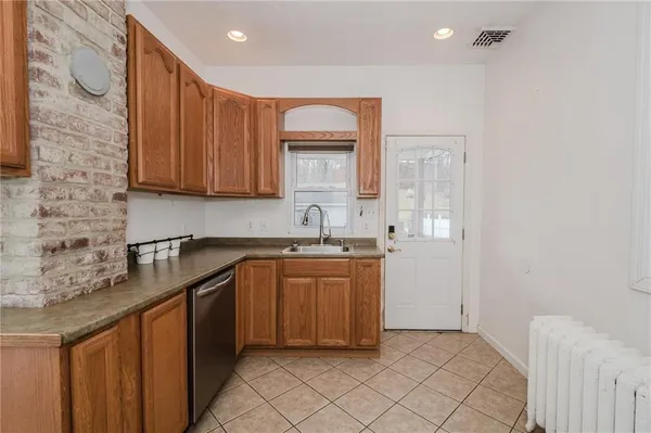a kitchen with a sink cabinets and a window