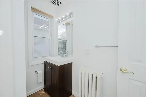 a bathroom with a sink a mirror and a shower