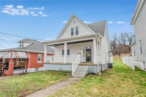 a front view of a house with a yard