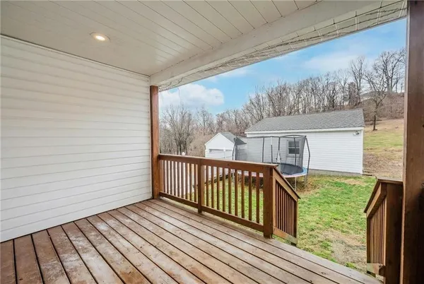 a view of a balcony with wooden floor